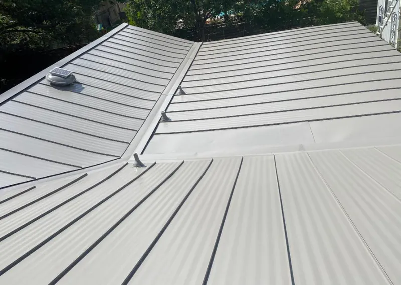 Solar attic fan installed on a metal roof for Roof Ventilation in Pittsburgh
